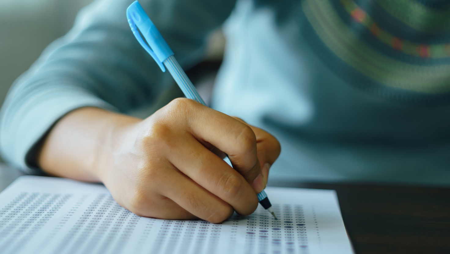 Student completing an exam answer sheet
